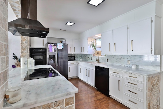 kitchen featuring island exhaust hood, white cabinetry, dark wood-type flooring, and black appliances