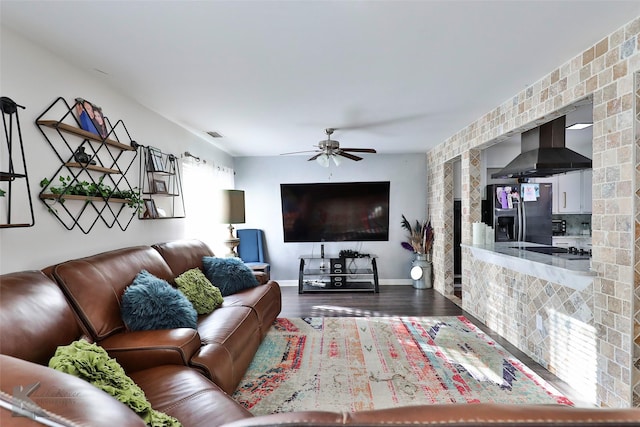 living room with ceiling fan and hardwood / wood-style flooring