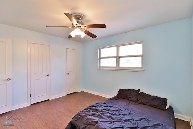 bedroom featuring ceiling fan and dark wood-type flooring