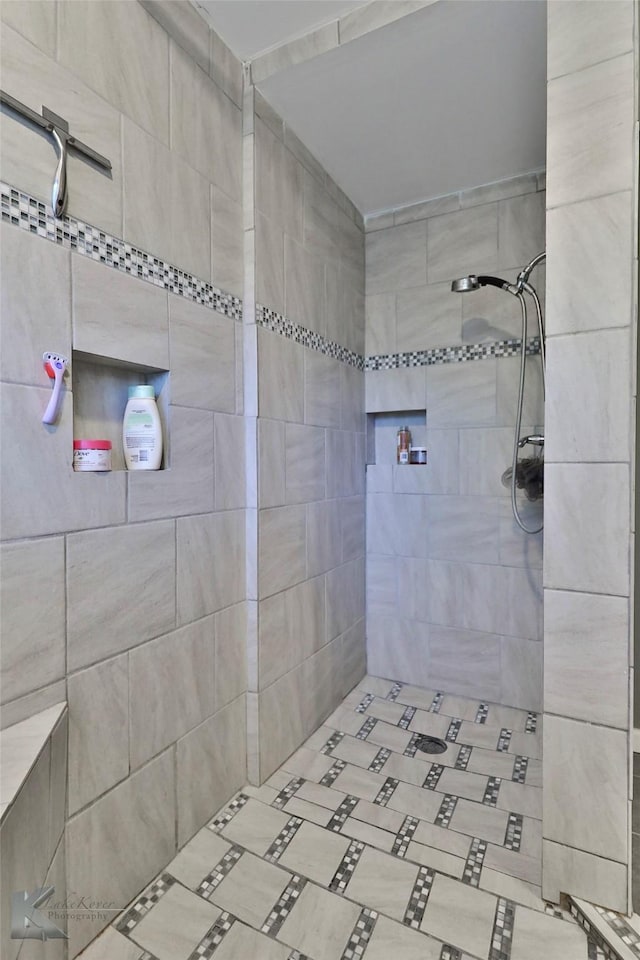 bathroom with tiled shower