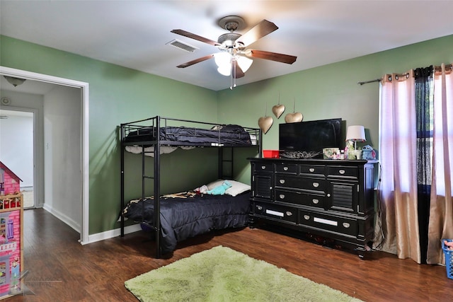 bedroom with ceiling fan and dark wood-type flooring