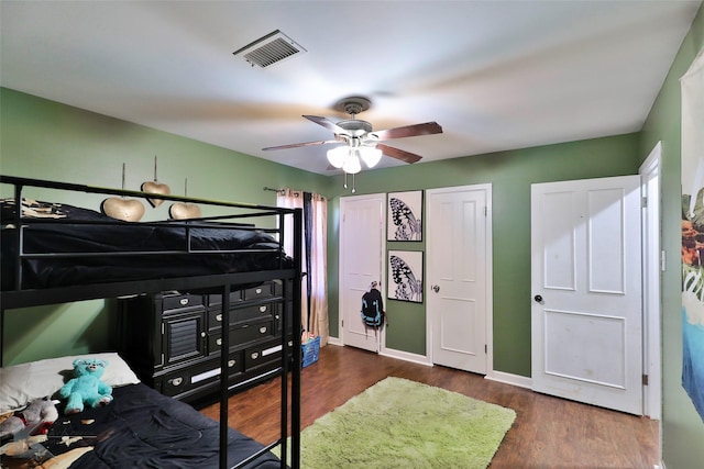 bedroom featuring ceiling fan and dark hardwood / wood-style floors