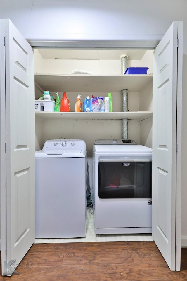 washroom with washer and dryer and dark hardwood / wood-style flooring