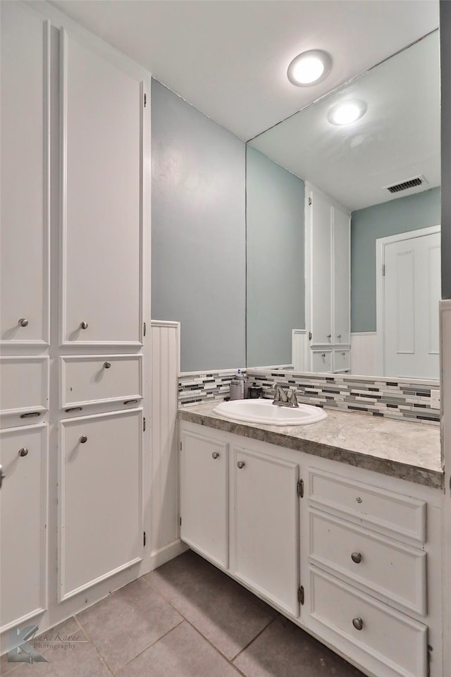 bathroom with tile patterned floors, decorative backsplash, and vanity