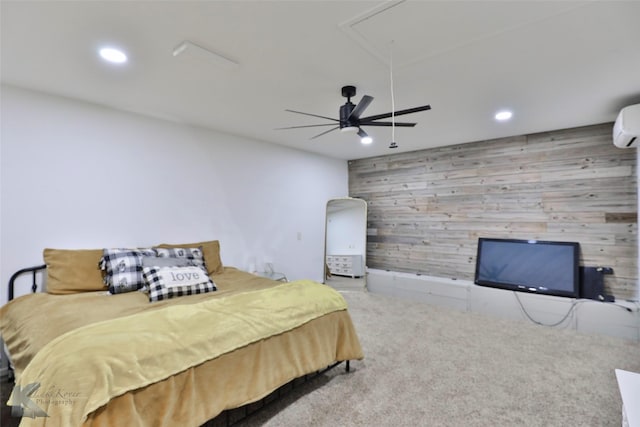 carpeted bedroom featuring a wall mounted AC, ceiling fan, and wood walls