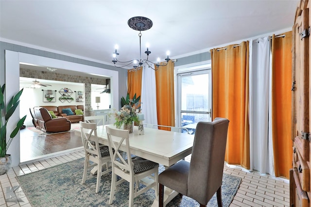 dining area with ceiling fan with notable chandelier, light wood-type flooring, and ornamental molding