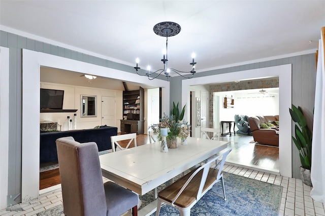 dining room featuring a chandelier, light wood-type flooring, and ornamental molding