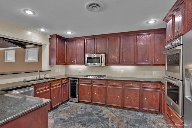 kitchen with wine cooler, sink, and appliances with stainless steel finishes