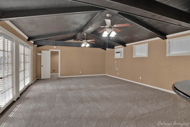 interior space featuring lofted ceiling with beams, carpet floors, a wall unit AC, and ceiling fan