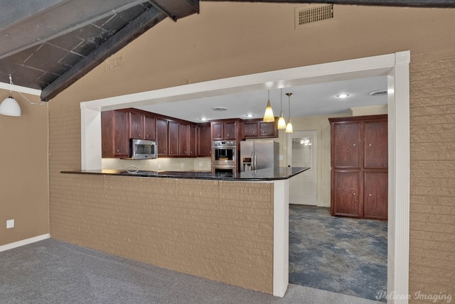 kitchen featuring hanging light fixtures, vaulted ceiling, kitchen peninsula, and appliances with stainless steel finishes