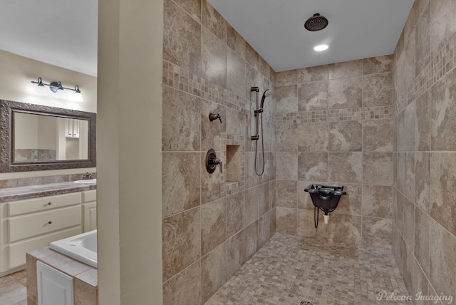 bathroom with vanity and shower with separate bathtub