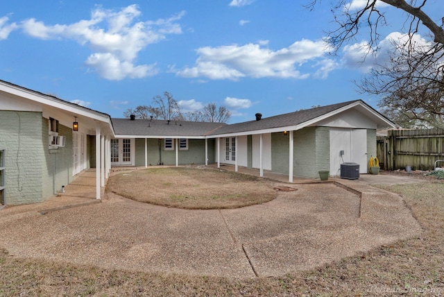 rear view of house with a lawn, a patio, and central air condition unit