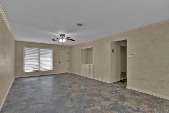 spare room with ornamental molding and ceiling fan