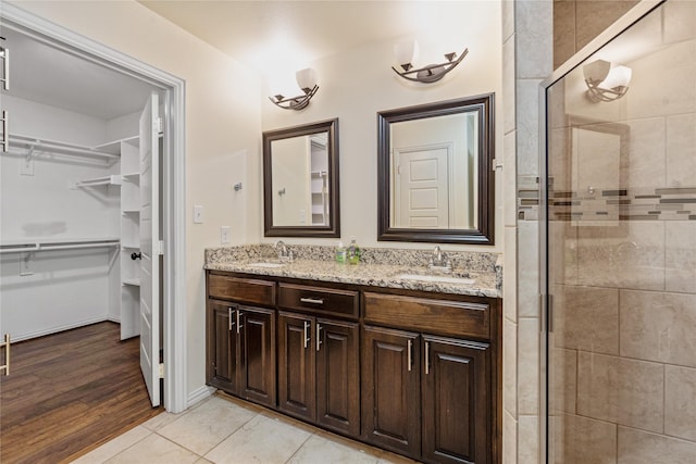 bathroom featuring vanity, tile patterned floors, and an enclosed shower