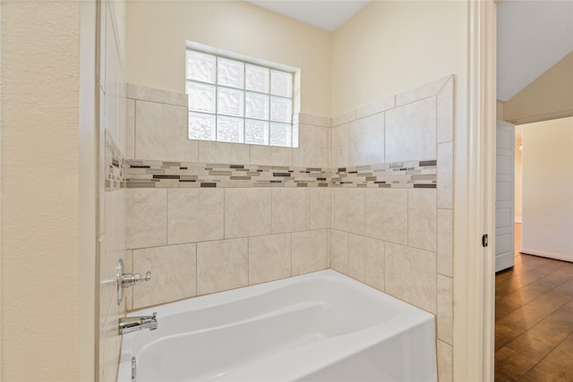 bathroom with a bathtub and wood-type flooring