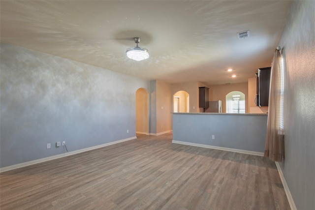 unfurnished living room with dark hardwood / wood-style floors