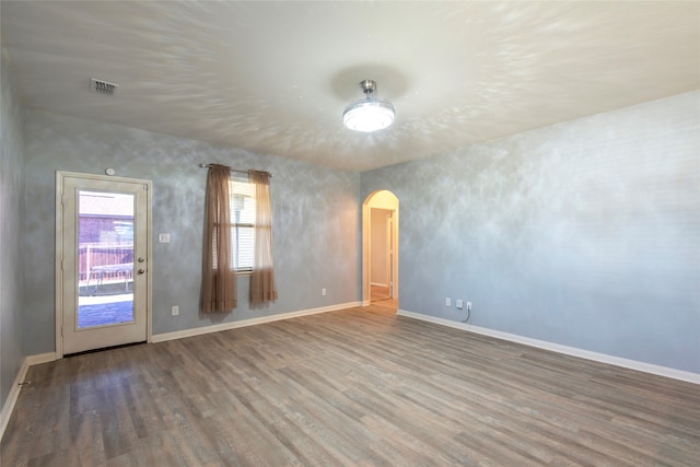 spare room with wood-type flooring