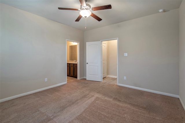 unfurnished bedroom with light carpet, ceiling fan, and ensuite bathroom