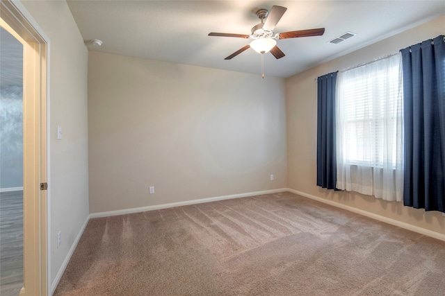 carpeted spare room with ceiling fan