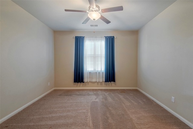 carpeted spare room with ceiling fan