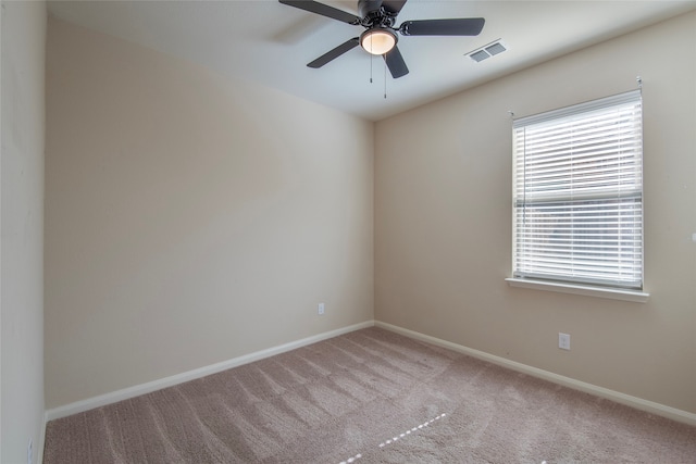 unfurnished room with light colored carpet and ceiling fan