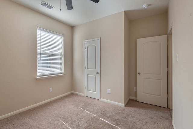 unfurnished bedroom featuring ceiling fan and light carpet