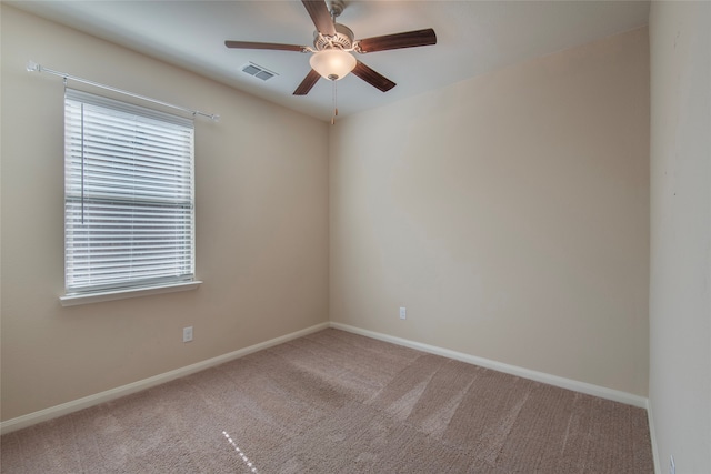 empty room featuring ceiling fan and carpet floors