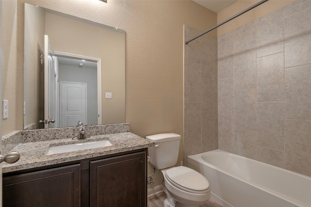 full bathroom featuring toilet, vanity, and tiled shower / bath