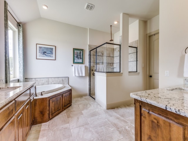 bathroom featuring vanity, separate shower and tub, and vaulted ceiling