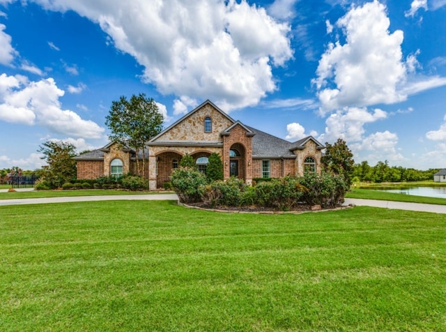 view of front of house featuring a front yard and a water view