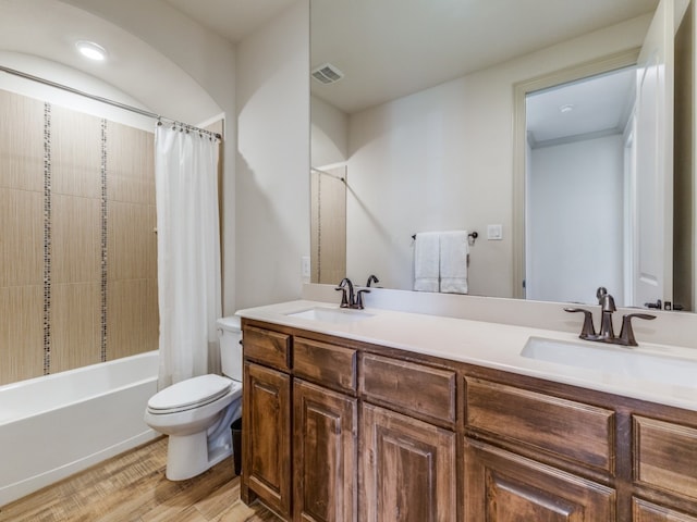 full bathroom with vanity, shower / bath combo, hardwood / wood-style flooring, and toilet