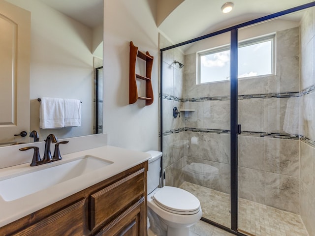 bathroom featuring vanity, tile patterned floors, toilet, and walk in shower