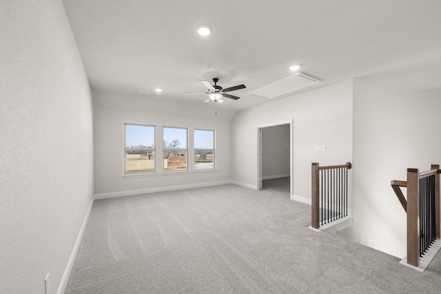 unfurnished room with ceiling fan, light carpet, attic access, and recessed lighting