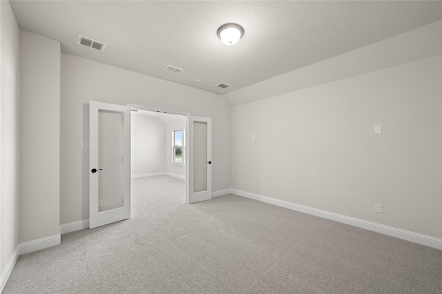 unfurnished room featuring visible vents, carpet flooring, baseboards, and french doors