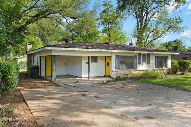 112 Pennsylvania Ave, Shreveport, LA 71105 - ranch-style home featuring concrete driveway, stone siding, an attached carport, and a chimney