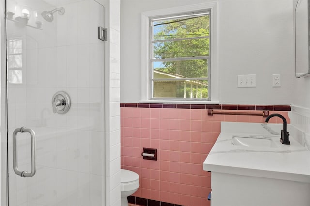 112 Pennsylvania Ave, Shreveport, LA 71105 - full bathroom with vanity, a stall shower, toilet, a wainscoted wall, and tile walls
