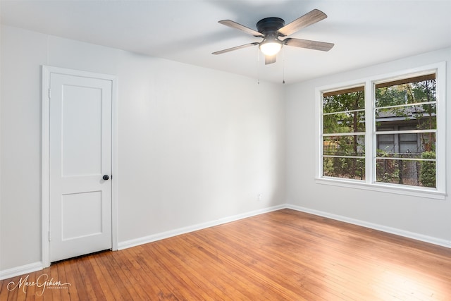 unfurnished room with baseboards, a ceiling fan, and light wood-style floors