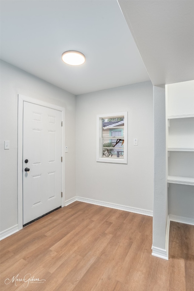 interior space featuring light wood-style flooring and baseboards