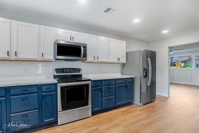 kitchen featuring decorative backsplash, light wood-style flooring, stainless steel appliances, light countertops, and blue cabinetry