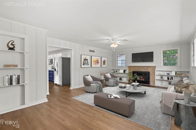 112 Pennsylvania Ave, Shreveport, LA 71105 - living area with crown molding, a ceiling fan, visible vents, built in shelves, and wood finished floors