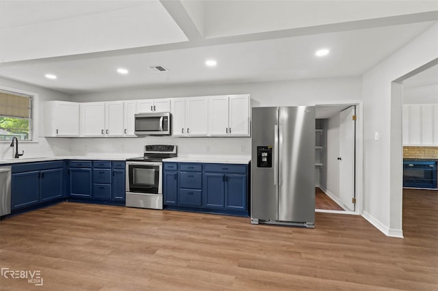 112 Pennsylvania Ave, Shreveport, LA 71105 - kitchen with a sink, backsplash, blue cabinets, and stainless steel appliances