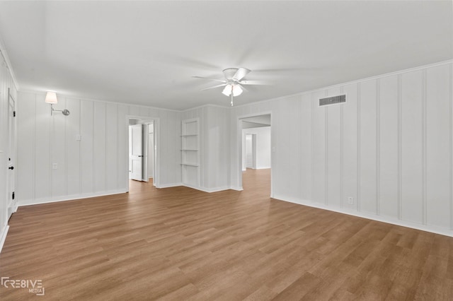 112 Pennsylvania Ave, Shreveport, LA 71105 - unfurnished living room with light wood finished floors, visible vents, a ceiling fan, and ornamental molding