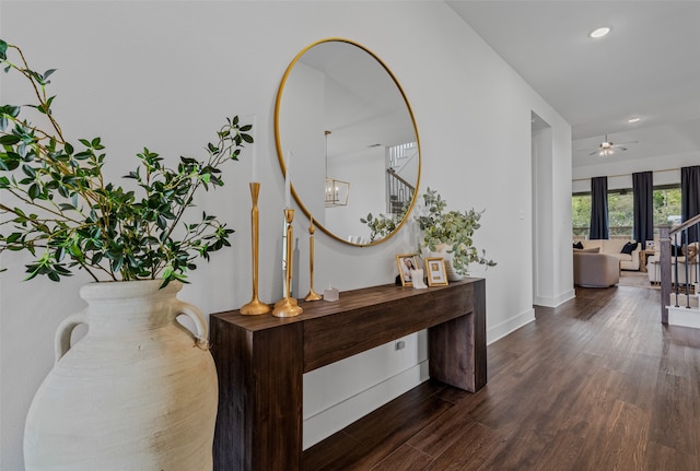 corridor featuring a chandelier and dark hardwood / wood-style flooring