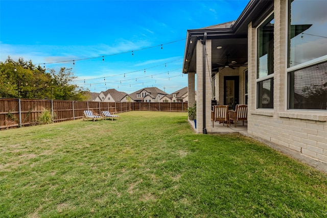 view of yard featuring a patio and ceiling fan