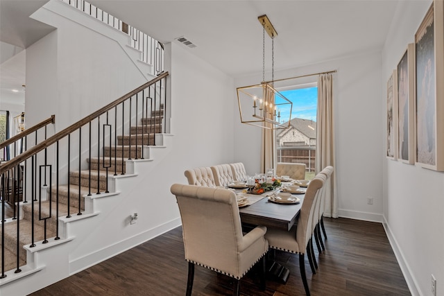 dining area featuring an inviting chandelier and dark hardwood / wood-style floors