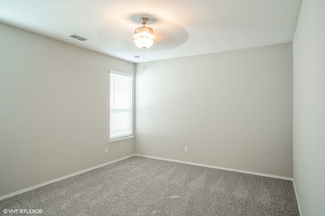 carpeted empty room featuring ceiling fan