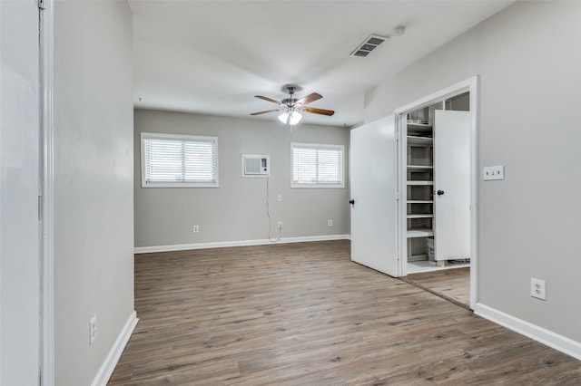 empty room with hardwood / wood-style flooring and ceiling fan