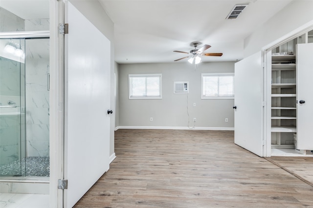 interior space featuring ceiling fan, light hardwood / wood-style floors, and a wealth of natural light