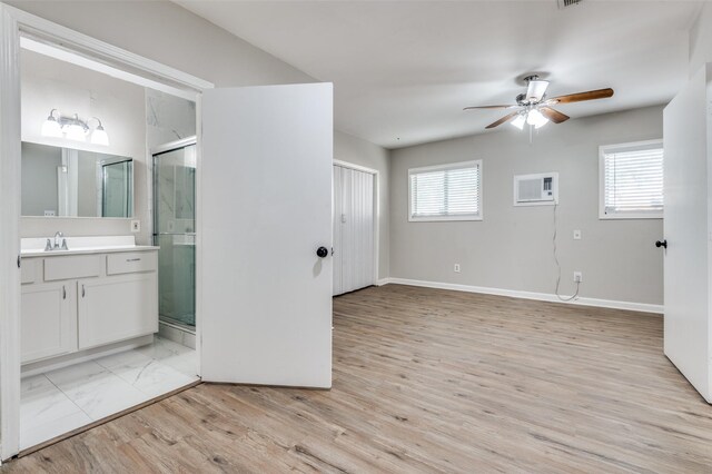 bathroom with ceiling fan, vanity, a healthy amount of sunlight, and wood-type flooring