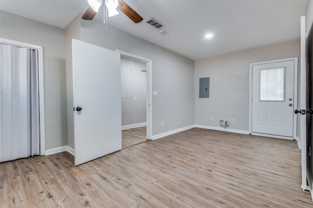 unfurnished bedroom with electric panel, light hardwood / wood-style flooring, and ceiling fan